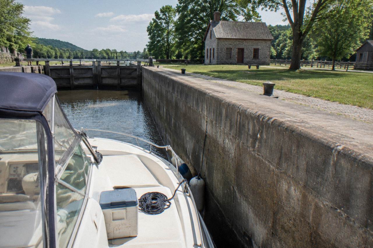 A canal boat passing through a concrete lock chamber on the Erie Canal