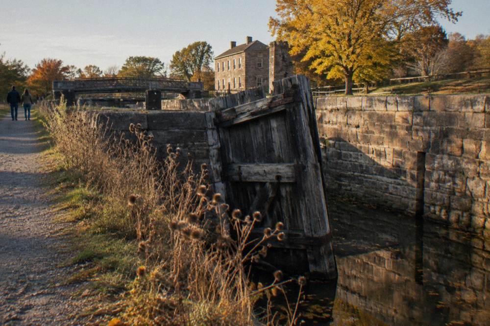 Historic stone lock walls along the Erie Canal with a wooden gate