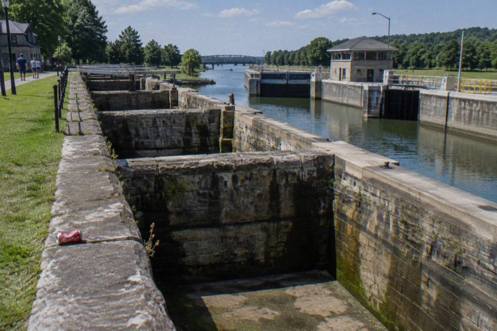 Old stone lock gates of the restored Flight of Five beside the modern Erie Canal locks