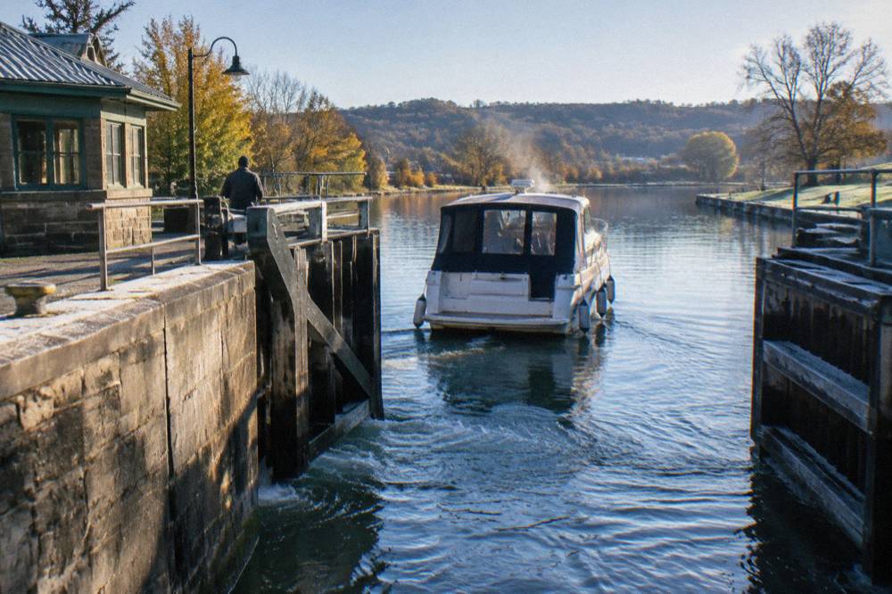 A lock chamber gate opening to release a boat into the canal