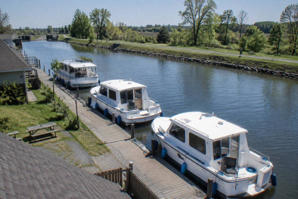 Canal boats moored in a row at a marina on the Erie Canal