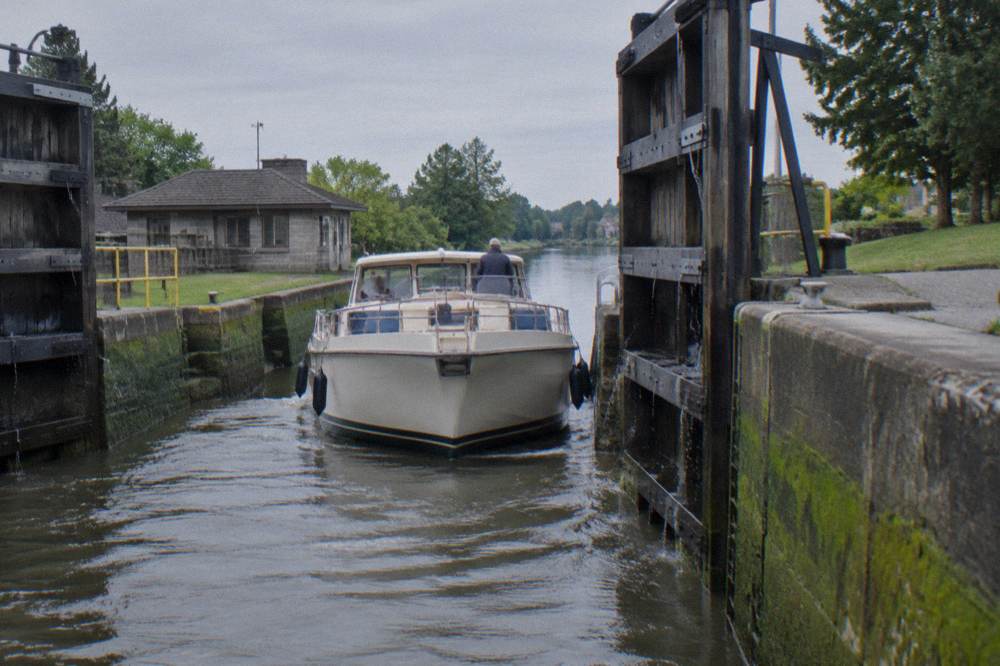 A canal boat passing through open lock gates on the Erie Canal