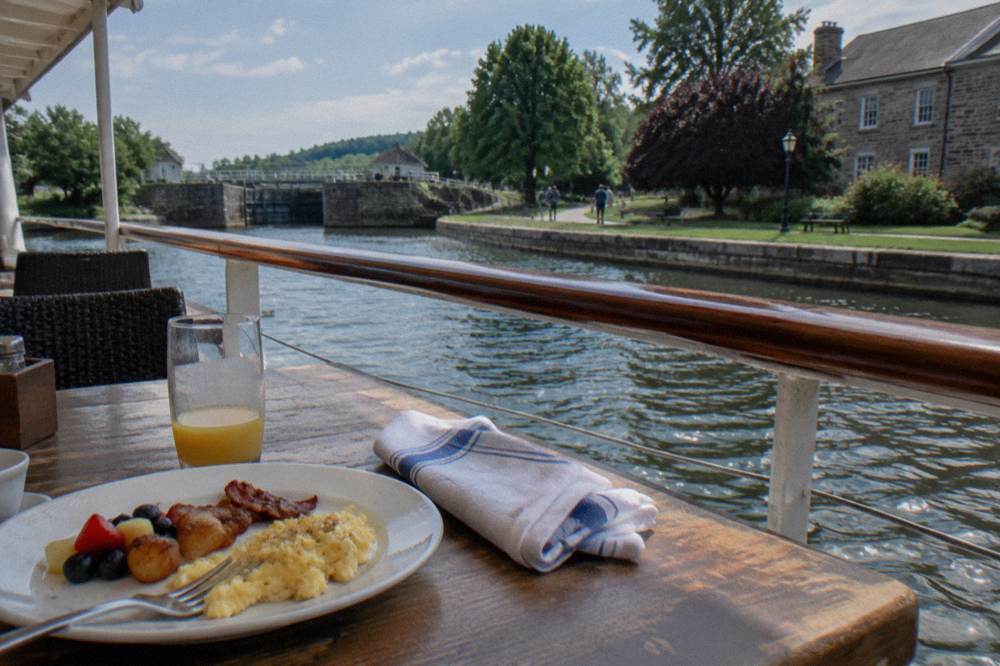 A table set for a meal on the deck of a canal cruise boat
