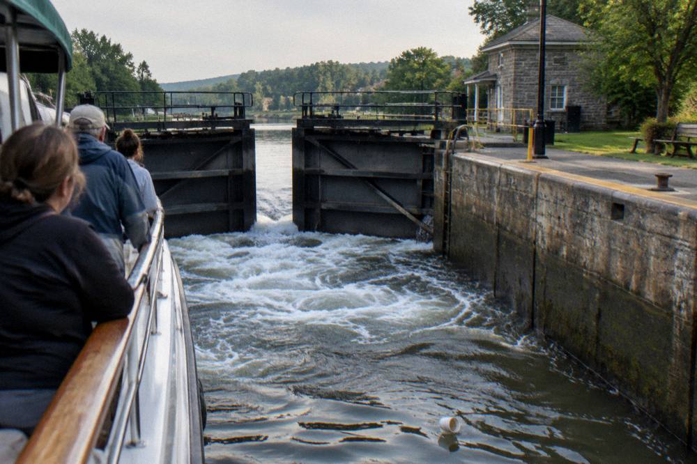 Passengers on a canal cruise boat watching the lock gates open