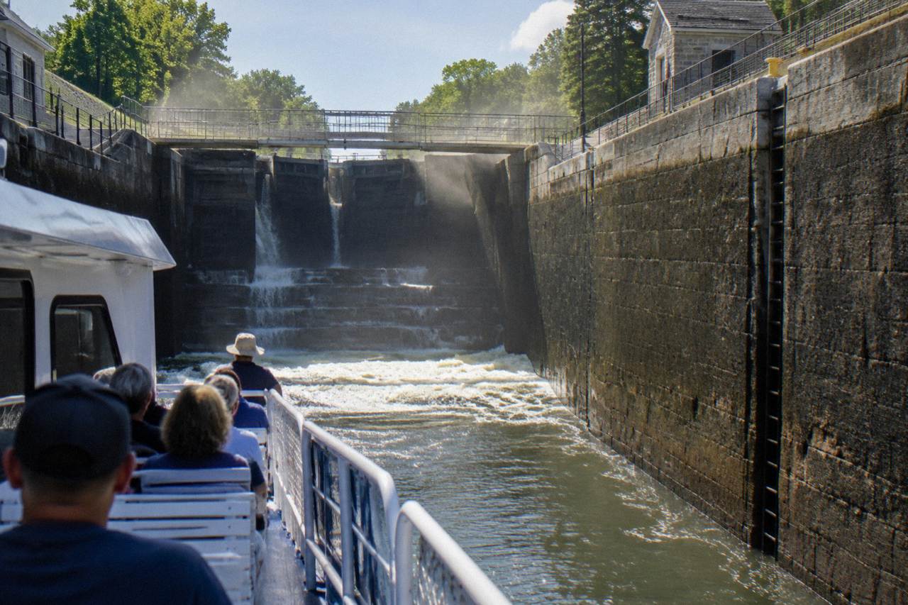A canal cruise boat passing through a lock on the Erie Canal