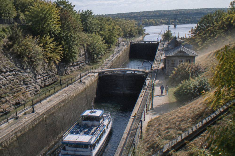 Aerial view of two canal lock chambers in sequence with a boat in the lower one