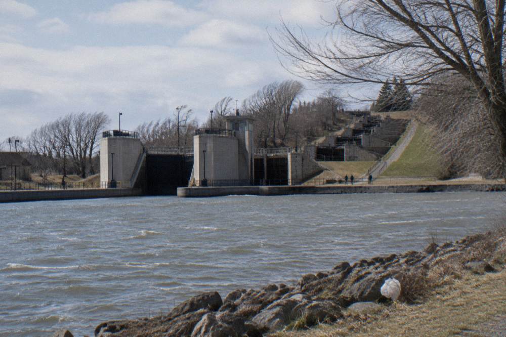 Twin concrete lock chambers at Lockport with the restored Flight of Five stone locks beside them