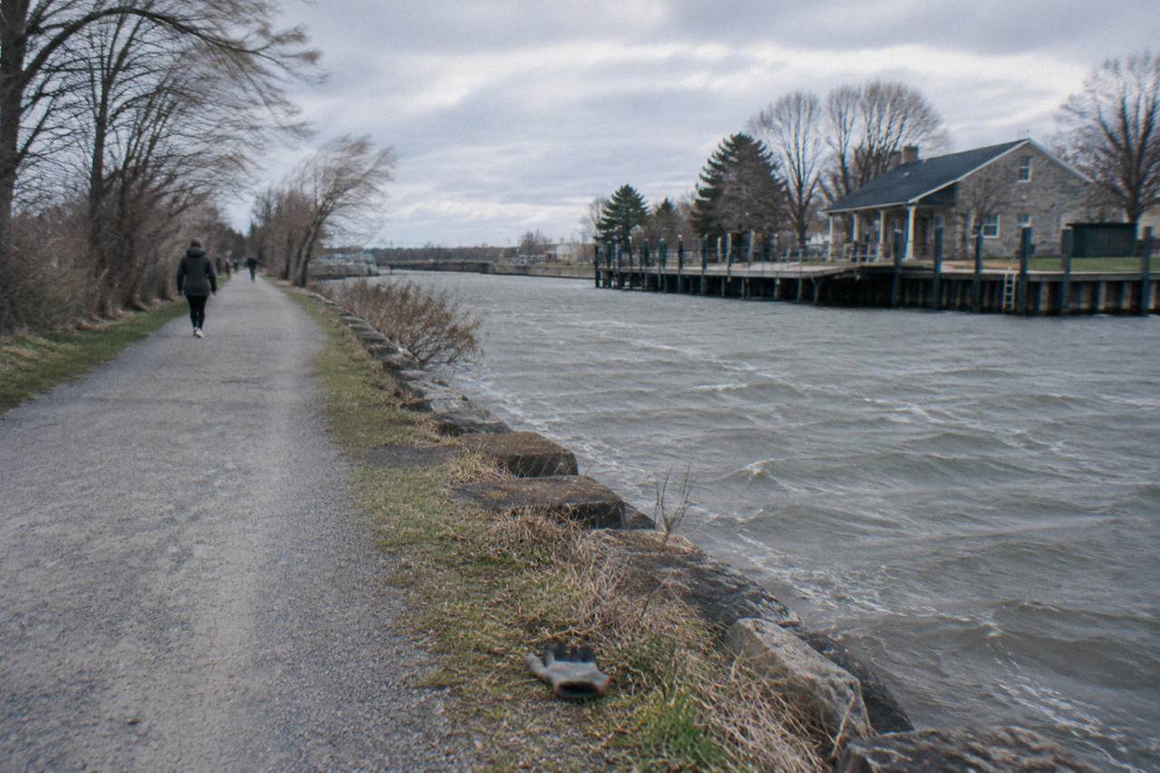 Stone dust trail beside the Erie Canal with a lift bridge in the distance